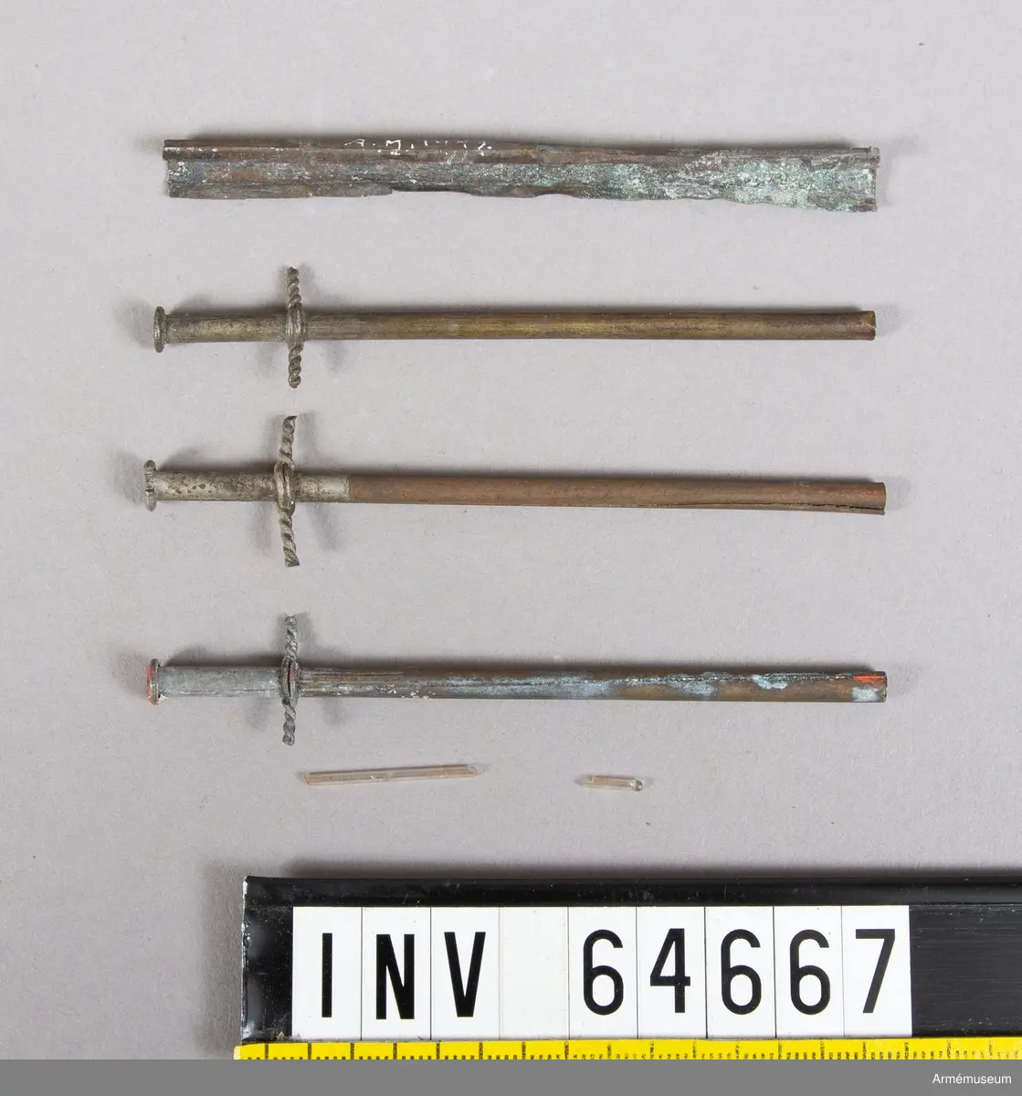 Grupp F II.
Antändningsrör. Callerströms invention 1829-30. Tändningen skedde genom att medelst en dragkrok avbryta rörets övre del, varvid där i ett glasrör förvarad svavelsyra utföll å klorsyrat kali, då explosion inträffade. Antogs vid fältartilleriet 1830.