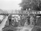 Samling intill Nykvarns sluss för en skål. Föreningstecknen skvallrar om att cyklisterna är medlemmar Linköpings Bicycleklubb. En rimlig datering torde vara 1890-tal.
