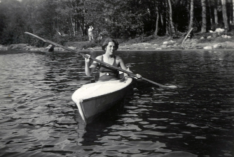 Eivor Dahlberg Bjerrhede (1921 - 2015) från Burås i Göteborg paddlar kanot på Tulebosjön, okänt årtal. Sommargäst hos Nilssons och Fredrikssons.