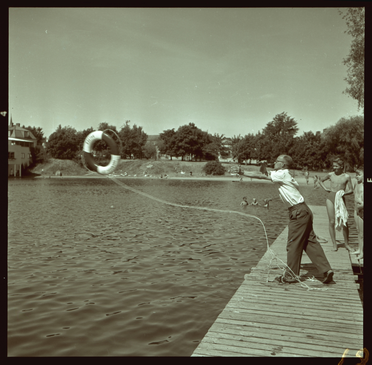 Orig. text: Sv. Livräddningssällskapet, Tinnerbäcksbadet.

Tinnerbäcksbadet öppnades den 19 juni 1938. Anläggningens slutliga utformning skapades av stadsarkitekten Sten Westholm. Den tidstypiska entré-, omklädnads- och restaurangbyggnaden är i stort ännu orörd sedan den uppfördes. Den drivande politiska kraften bakom badet var köpmannen Axel Brunsjö. I vissa kretsar kallades badet för Brunsjön, efter köpmannens stora engagemang för badet och som senare kom att bli badets föreståndare.
