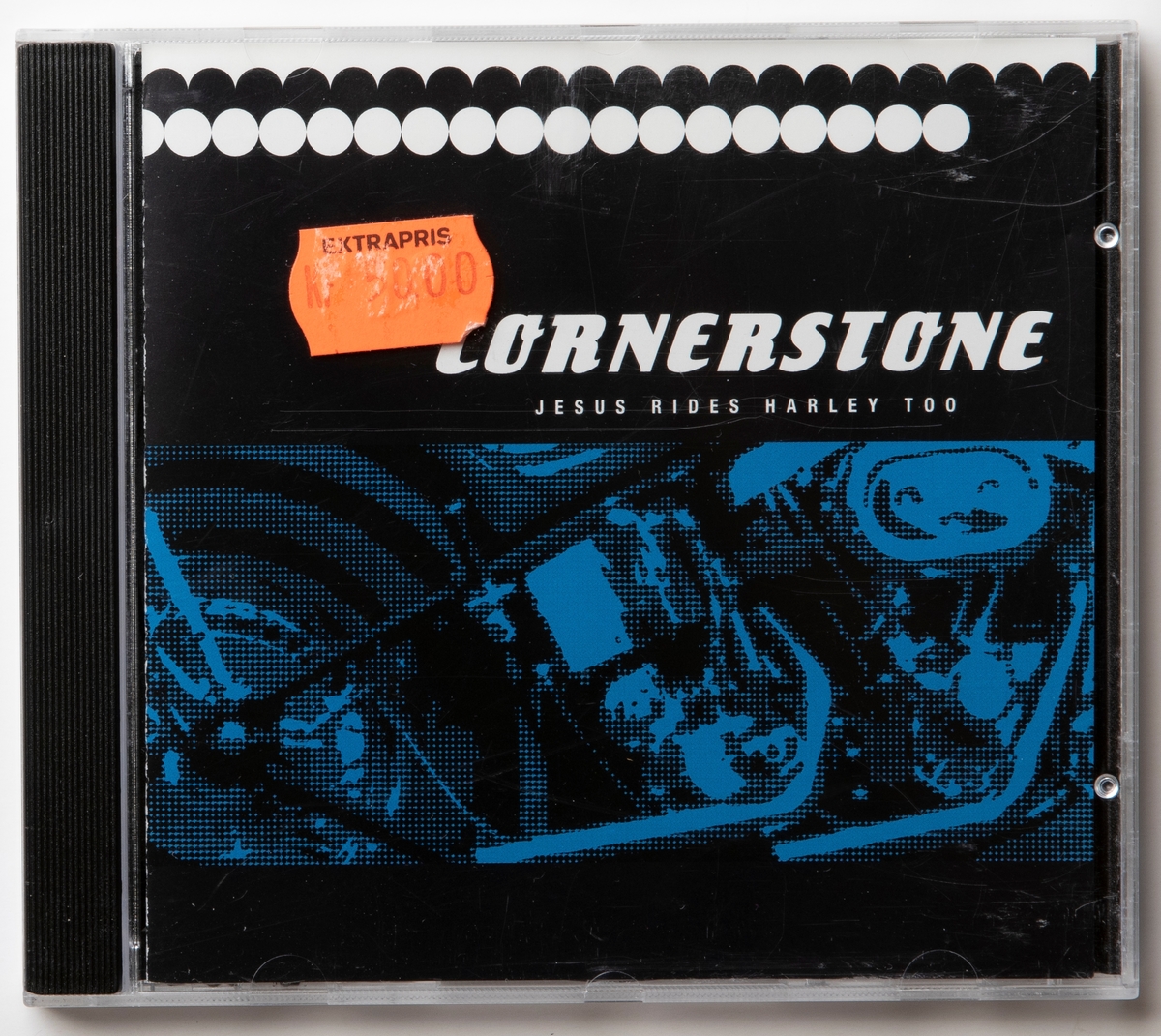 CD-skiva med musik med gruppen Cornerstone. Skiva i tredelat, hårt plastfodral med booklet (häfte) i framsidan och inlaga i baksidan. På framsidan sitter orange prislapp märkt "Kr 50.00".

Innehåll:
1. Dreamer
2. Jesus rides Harley too
3. Faith
4. Moover
5. Dance
6. Living a lie
7. Jesus is comming soon
8. Stone
9. Check it out
10. Down down
11. Blues town jam

JM 55284:1, Skiva
JM 55284:2, Fodral
JM 55284:3, Booklet