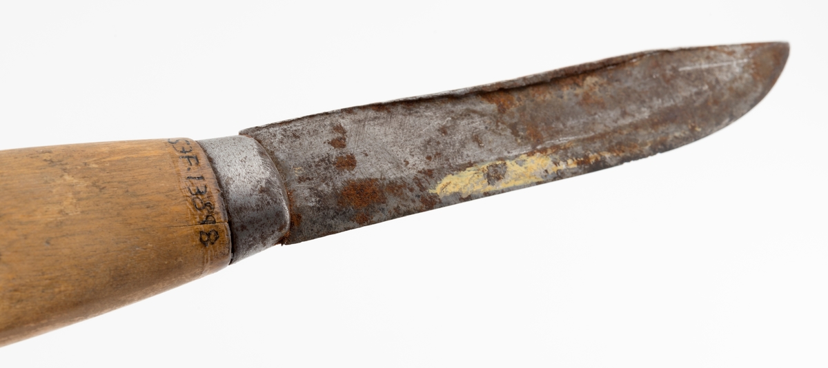 Tollekniv med slire, produsert av B. Knudsen på Ila i Trondheim. Kniven er 22,3 centimeter lang fra spissen av bladet til knappen i den bakre enden av skaftet. Bladet er 11,1 centimeter langt og snaut 2,1 centimeter bredt ved brystningen innerst mot skaftet. Bladet var opprinnelig snaut 3 millimeter tjukt, men bladryggen har slagmerker som har gjort den noe bredere. Sannsynligvis har dette skjedd fordi eieren har slått på knivnakken med et slagredskap for å kunne kløyve stikker som skulle brukes under opptenning. Den venstre sida av knivbladet bære smedstempelet «B. KNUDSEN  ILEN  TRONDHJEM». 

Kniven har et 10,8 centimeter langt treskaft med cirka 1 centimeter brede holker i begge ender. I den bakre enden er det en cirka 5 millimeter høy knopp med skråslipt endeflate. Treskaftet har en konveks form og et ovalt tverrsnitt. Midtpartiet måler 2,9 X 2,2 centimeter. Skaftet er ikke innsatt med noe fargestoff, men det kan ha vært oljet.

Slira er 18,2 centimeter lang, men har i tillegg en lærstropp for feste i en knapp i bukselinninga, slik at total lengde blir 24,6 centimeter. Sliras hoveddel er lagd av brunlig papp og holdes sammen av en søm langs det som var midtaksen av sliras bakside. Forsida av den delen av slira som omgav knivbladet har et siksak-mønster med litt skravur.

Knivmakerne Broder Knudsen (1886-1967) og Bård Knudsen bodde i Trondheim. Det er sannsynlig at en av disse har produsert denne kniven.