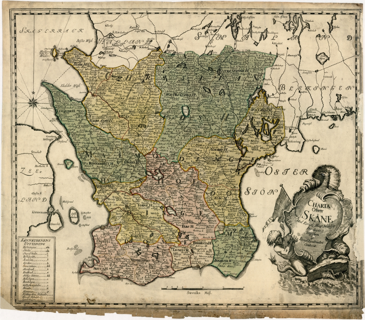 Karta över Skåne från 1770-80. Invid titeln avbildas en tvåtungad flagga, en man med fiskstjärt m m.