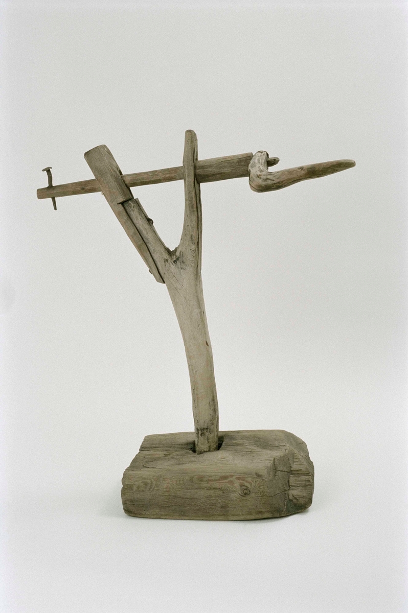 Vev av trä tillhörande tvinnmaskin, för repslageri. Fot av tjock bräda, Y-formad ståndare, ena bygeln förlängd med påspikad träbit. Vev med handtag, en uppstående spik i andra änden.