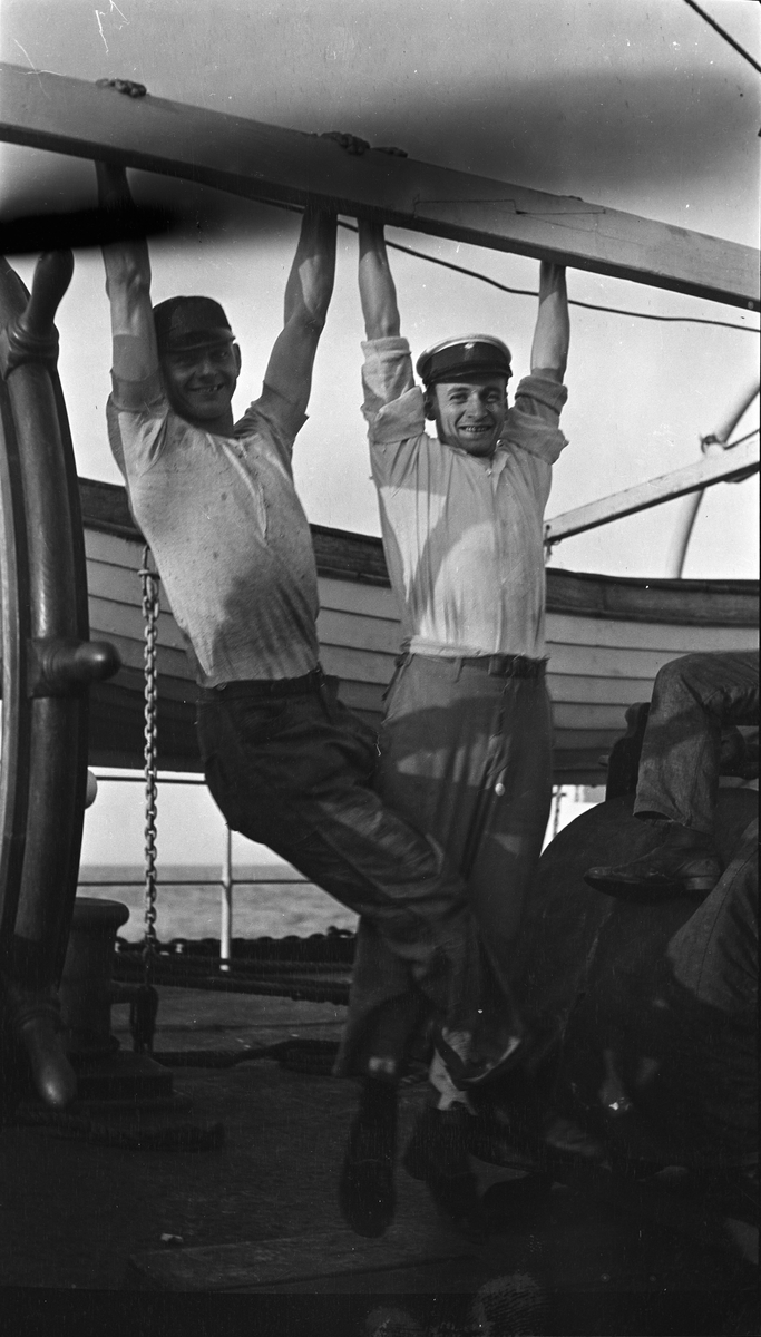 To menn henger i en bom på dekk på DS STORFOND, Lars Johansen til høyre.