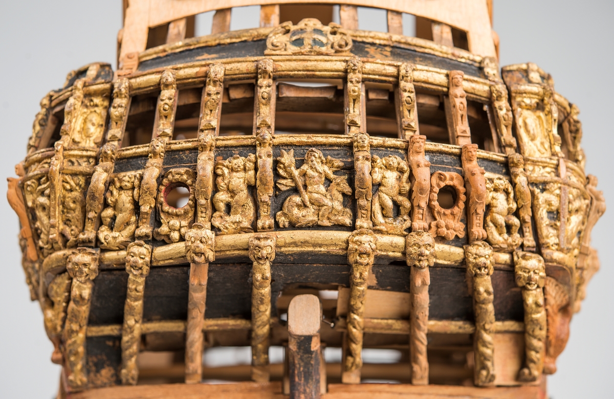 This unplanked model of a three-decker can be dated to c. 1660 and is one of the world's oldest models of a warship. Although not definitively identified, recent research links it to the Swedish ship *Riksäpplet*, designed by the English master shipwright Francis Sheldon and launched in 1661.     
The model was possibly made for Sheldon, who came to Sweden in 1659. He was one of a number of English shipwrights employed by the Swedish crown during the period. Previously, most Swedish warships had been built in the Dutch style.

From around 1660, the English Royal Navy’s administrators commissioned models that were accurately detailed and true to scale. These miniatures, which came to be called Navy or Admiralty Board models, had an unplanked lower hull to emphasise the shape of the underwater body. 

The model was restored by rear-admiral Jacob Hägg in the late 1890s. Missing parts have been reconstructed using lighter coloured wood.

3D model produced by Adam de Kaminski and Vasilis Haroupas for SMTM, 2023
