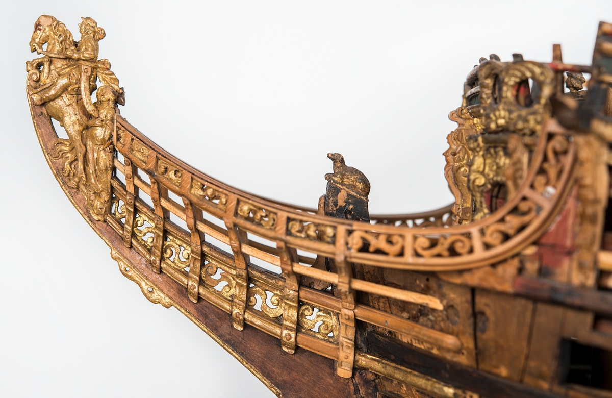 This unplanked model of a three-decker can be dated to c. 1660 and is one of the world's oldest models of a warship. Although not definitively identified, recent research links it to the Swedish ship *Riksäpplet*, designed by the English master shipwright Francis Sheldon and launched in 1661.     
The model was possibly made for Sheldon, who came to Sweden in 1659. He was one of a number of English shipwrights employed by the Swedish crown during the period. Previously, most Swedish warships had been built in the Dutch style.

From around 1660, the English Royal Navy’s administrators commissioned models that were accurately detailed and true to scale. These miniatures, which came to be called Navy or Admiralty Board models, had an unplanked lower hull to emphasise the shape of the underwater body. 

The model was restored by rear-admiral Jacob Hägg in the late 1890s. Missing parts have been reconstructed using lighter coloured wood.

3D model produced by Adam de Kaminski and Vasilis Haroupas for SMTM, 2023
