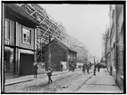 Tvåvånings bostadshus under rivning.
Storgatans breddning.
Storgatan mot söder från Järnvägsgatan.
Reproduktion (1934) efter en äldre bild från ca 1904.