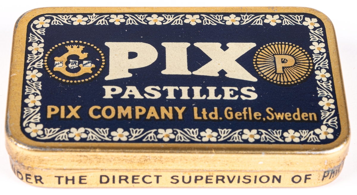 Tablettask i plåt, guldfärgad och blå botten med vit och guldfärgad text:" PIX PASTILLES PIX COMPANY LTD. GEFLE. SWEDEN".