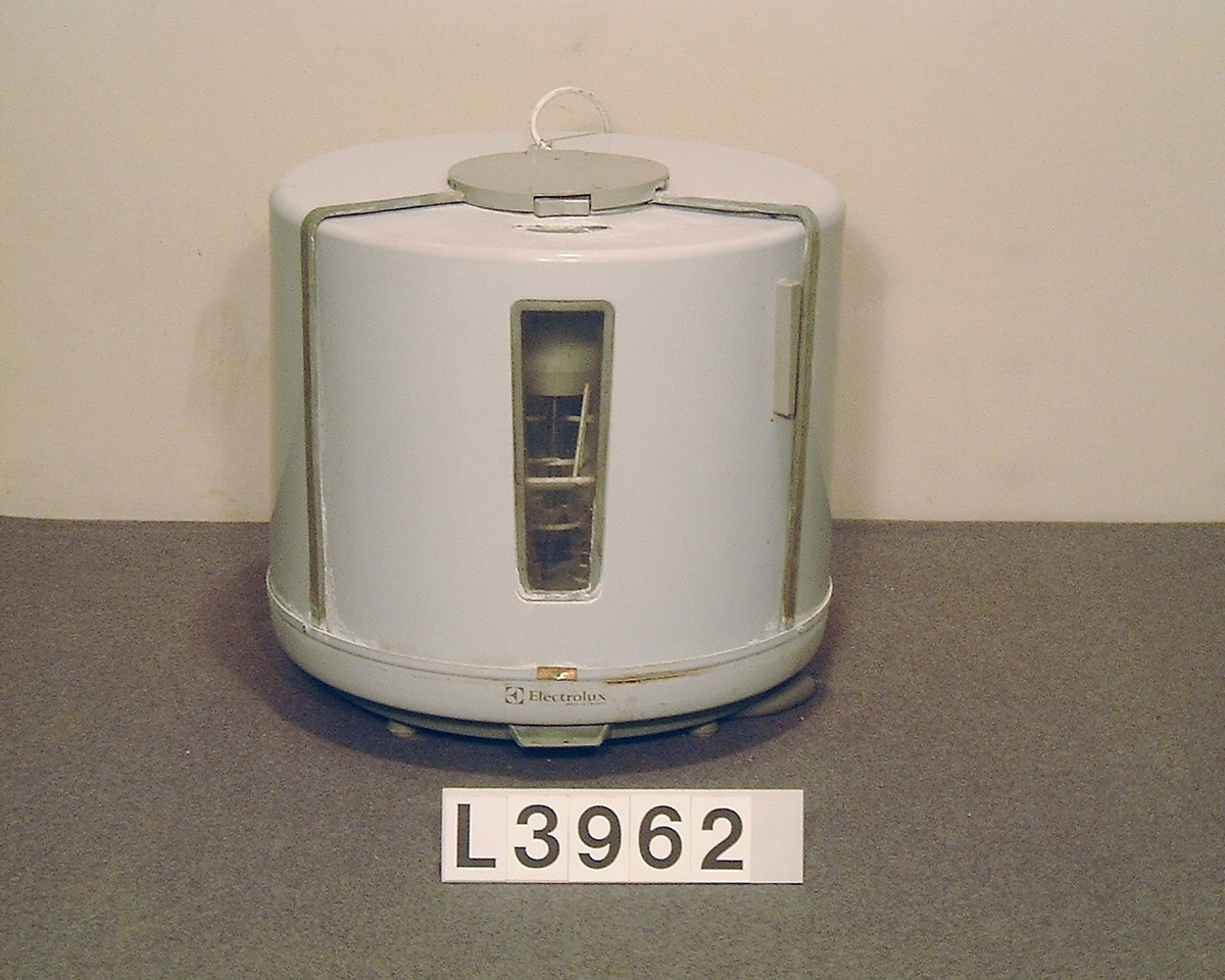 Electrolux  bänkdiskmaskinen  D10c "runda burken". Cylindrisk bänkdiskmaskin med skjutlucka och hela apparaten är lackerad i grå- vitt med grå gummi lister. Gummilisterna är torra, midjelisten är borta och påtappningsslangen är ej original.