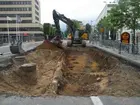 Avbanad del av Västra skolgatan, intill korsningen Brånebacken, med fyra stenskodda stolphål på rad och en ränna.