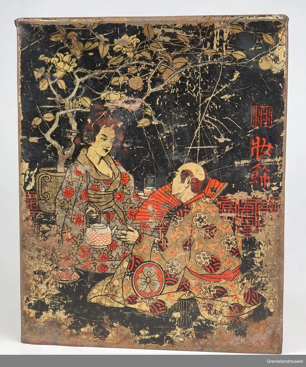 Blikkboks. Svartlakkert. Påmalt japansk par og japanske skrifttegn.