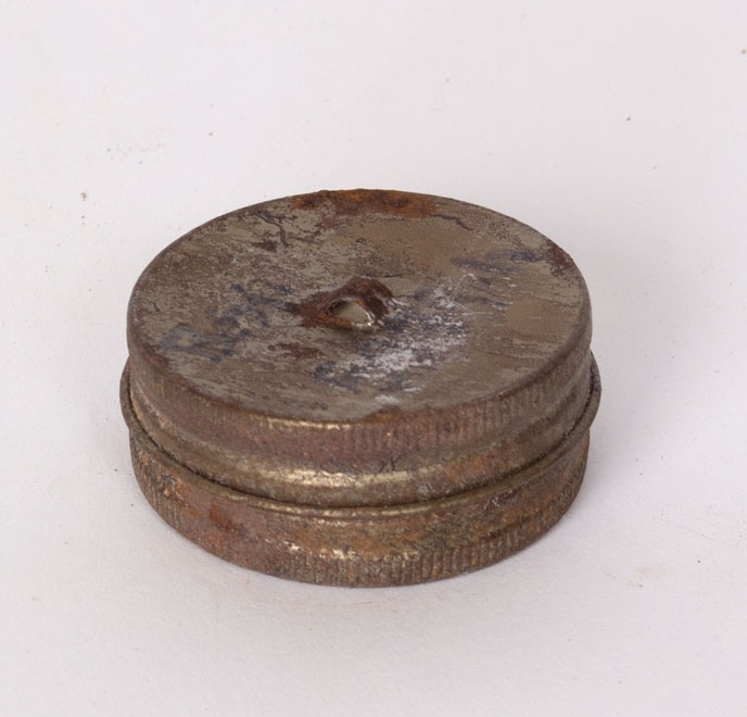 Runde metallbokser til pusseklut. Boksen er rustet fast og ikke mulig å åpne.