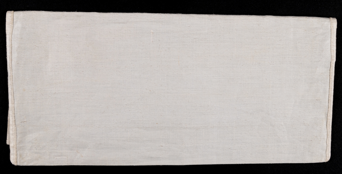 Servettväska i vitt linne med venetianskt broderi. Fodrad med grönt råsiden.