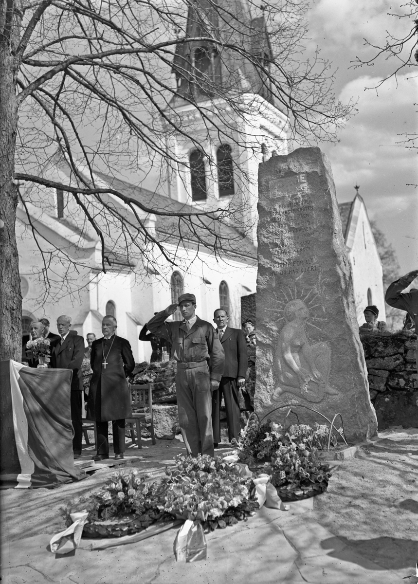 Minnemarkering ved Eidsvoll Kirke. Bauta over falne under 2. verdenskrig. Martin Johansen til høyre. Otto Norheim og biskop Berggrav til venstre for soldaten. På bautaen står: ”Falt for Norge 1940-1945.” Under står 8 navn: Paul Kristian Aulie, Lars Larsen Bråten, Olaf Gulliksen, Bjarne Johnsen, Kristian Karlsen, Cato Krüger Storm, Gunnar Strand, Oddvar Wenger.