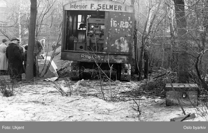 Bygging av dekningsgraver, beskyttelse mot flyangrep, bombeangrep. Gravemaskin fra Ingeniør F. Selmer. Fra album "Dekningsgraver i arbeide for Oslo kommune". Fotografert ved befaring 23. mars 1940.