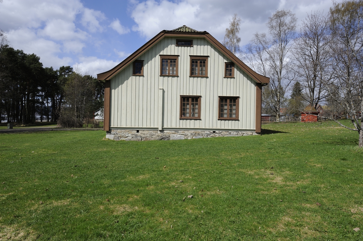 Bygningen er i en og en halv etasje, laftet og panelt. Taket er halvvalmet med teglstein.  Bygningen har to skorsteiner. Planløsningen er en tradisjonell midtkammerbygning. Inngangen er midt på langveggen. Inngangsdøra er en tofløyet fyllingsdør med et smalt vindusfelt over. Gangen har trapp opp til annen etasje og dør inn til stue, kjøkken og ei mindre stue. Kjøkkenet ligger rett innenfor gangen. I kjøkkenet har det opprinnelig vært peis, men denne er ganske raskt erstattet av en stor jernkomfyr. Innenfor kjøkkenet er det et spiskammers. Til venstre for gangen ligger storstua med et kammers innenfor. Storstua har jernovn. Til høyre for gangen ligger ei mindre stue med jernovn. Herfra er det inngang til spisestua. Dette rommet har også inngang fra kjøkkenet. Rommet har malt sjablongdekor i pompeiansk stil. Spisestua har jernovn. Alle rommene nede er panelt og malt. Stua har sjablongdekor. I Annen etasje er det en stor gang med inngang til et stort soverom i hver ende. Det er også åpninger til smale kott på utsiden av rommene i hele bygningens lengde. Veggene i annen etasje har vært rappet og tapetsert. Fra gangen er det trapp opp til et stort loft. Bygningen har 21 vinduer. Fire av vinduene, to på hver gavlvegg, er smale lysåpninger som skal gi lys til sidekottene i andre etasje. Det er også en smal loftsglugge øverst i hver gavlvegg.