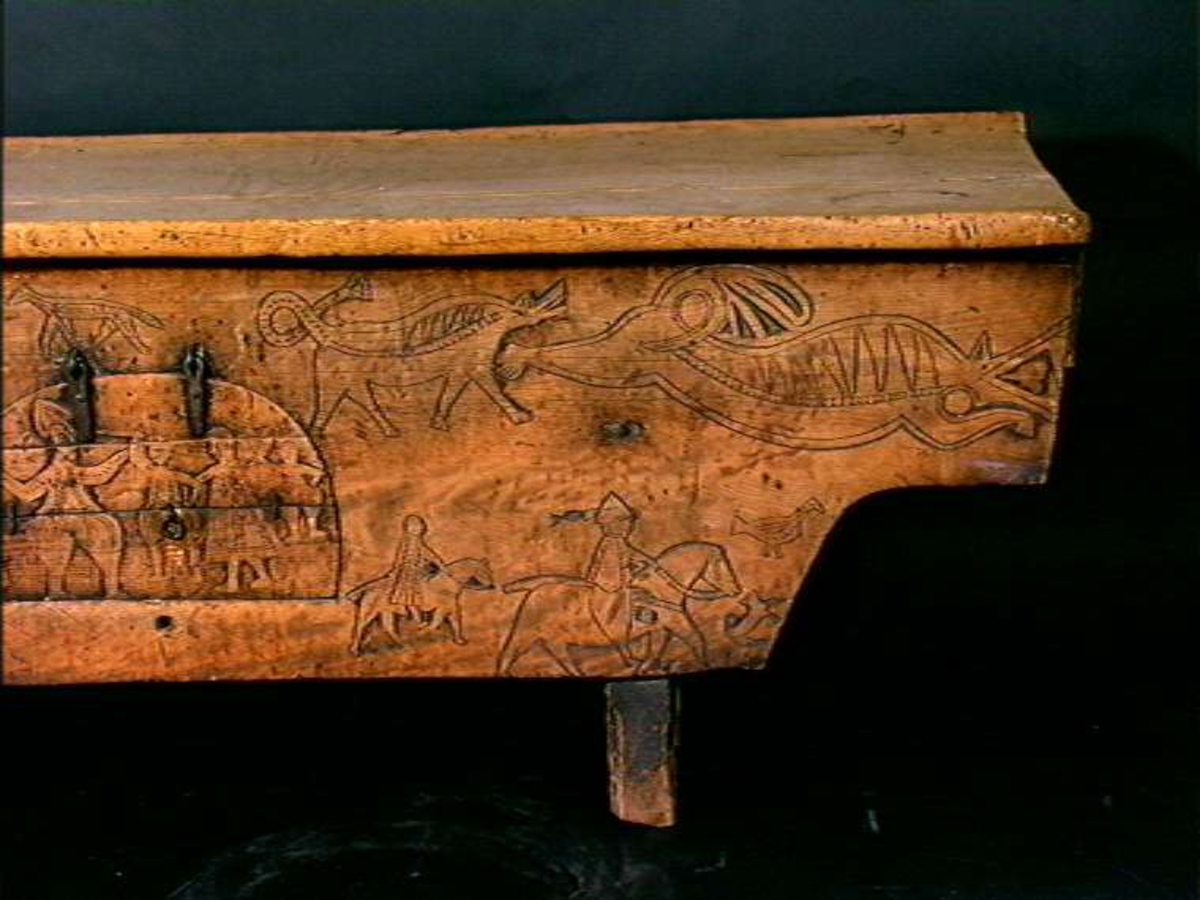 Bordplate og sider til bordet et laget av én tømmerstokk. Bendelene er skåret som formen til innsiden og sikret med dømlinger. Bordet har en frontside  med skurd og rispet dekor med middelalderspreg. Frontsiden har også en bueformet luke med hengsling nedtil. Undersiden er hvert dekket, så eneste inngang er fra luken. Bordet er ubehandlet.