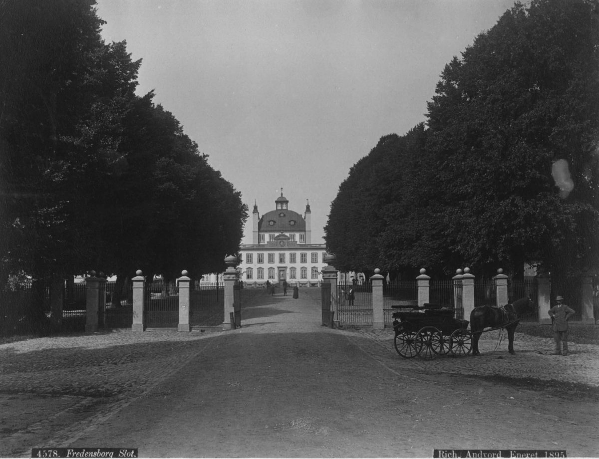 Postkort. Fredensborg Slott med innkjørselen og gjerdet.
 rundt eiendommen.