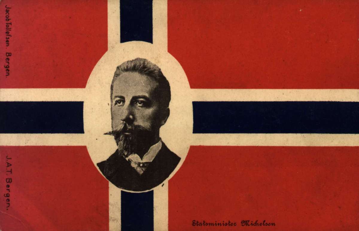 Postkort. Nyttårshilsen. Fotografisk motiv. Portrett av statminister Christian Michelsen (1857-1905). I bakgrunnen det norske flagget. Stemplet 30.12.1905.