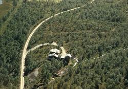 Flyfoto. Oversiktsbilde med bebyggelse fra ukjent sted i Sør