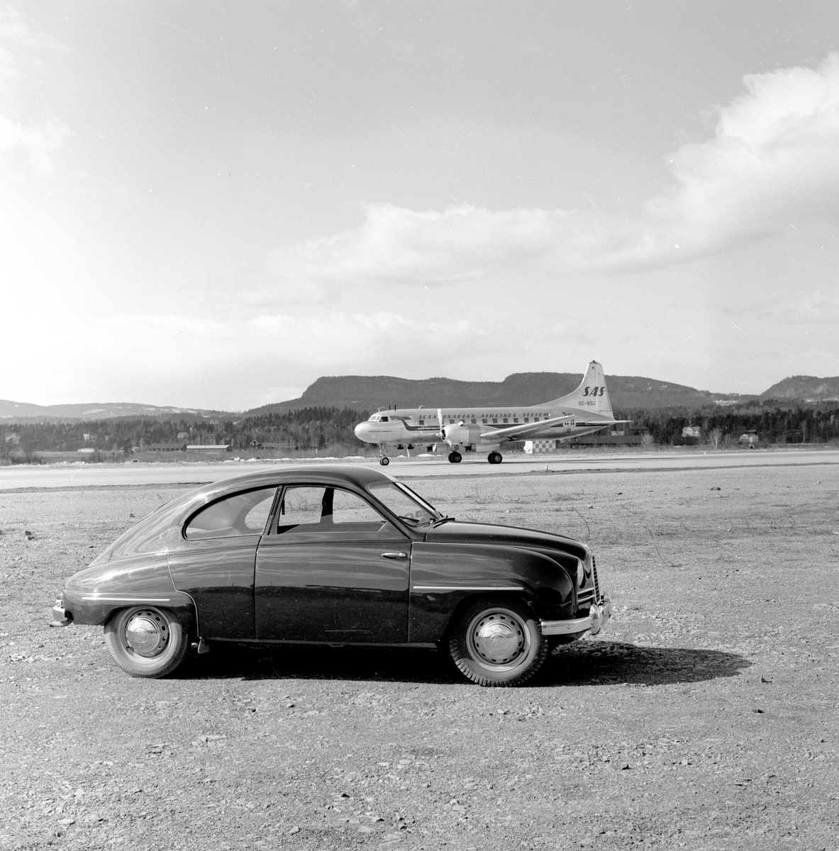 En SAAB og et fly fra SAS på rullebanen ved Fornebu flyplass.