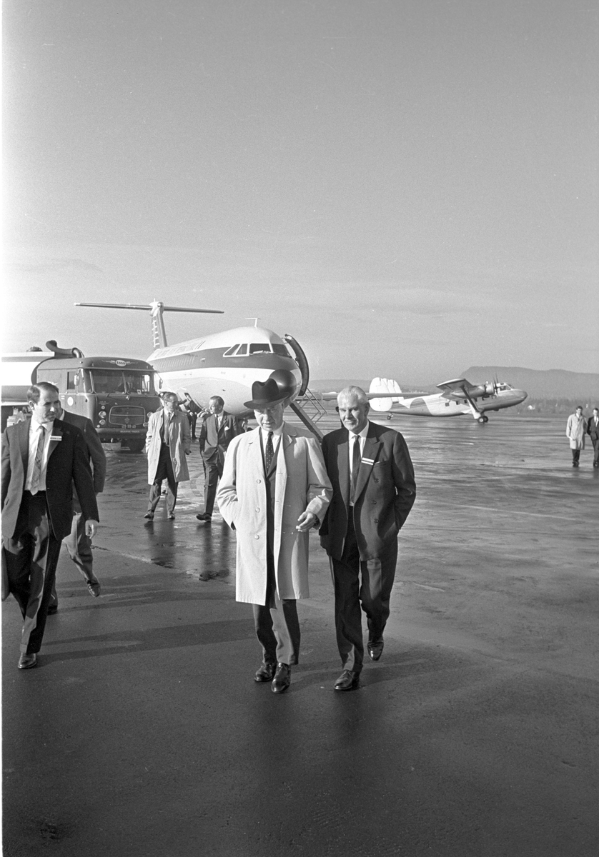 Serie. Menn fra Braathens SAFE inspiserer jetflyet fra "Aer lingus irish international". Et propellfly er i ferd med å lette i bakgrunn. Fotografert oktober 1965.