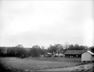 Landskapsvy med Lagga kyrka, Lagga socken, Uppland 1917