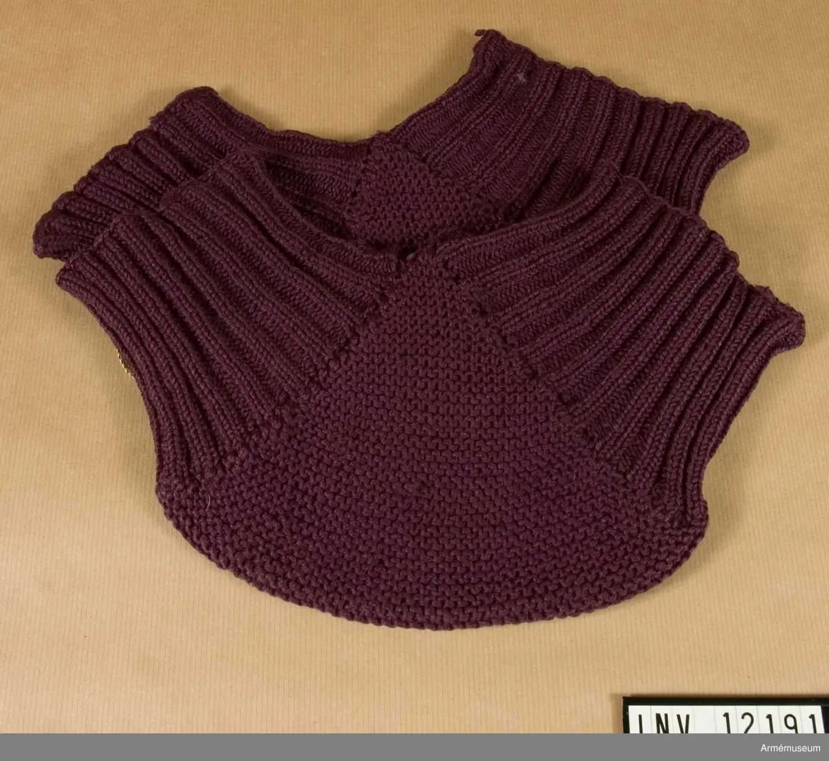 Grupp C I.
Knäskydd av stickat ylle. Violett. Beredskapstiden 1939 - 1945.