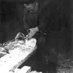 Neg nr 306, Öskaret gröpes ur med yxa. Foto 24.8 1962.