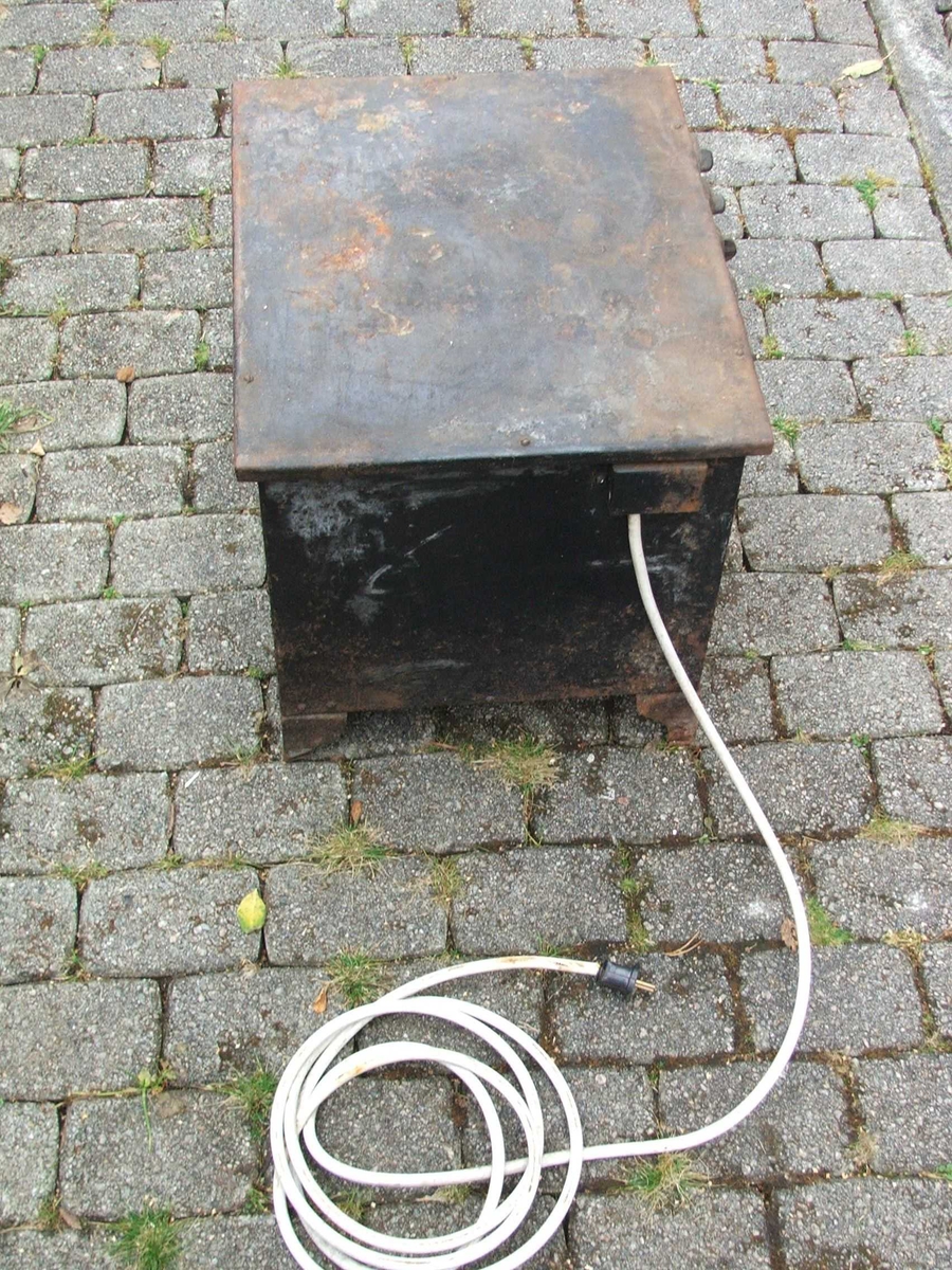 Elektrisk steikjeomn. Dør på eine kortsida med lukkemekanisme øvst. Tjukke veggar. Inni er det to lause steikjeplater. Det er spor til å setje plater på på veggane. Ei plate har kant, den andre ikkje. Øvst på eine langsida er det fire brytarar. Ledning kjem ut på kortsida bak.