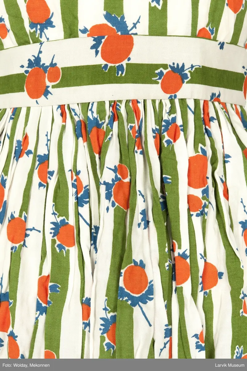 Trykket motiv med grønne striper og oransje "frukter" med blå blad og stilk