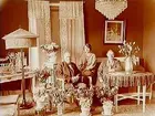 Rumsinteriör, familjegrupp tre personer.
Gustaf Eson. Anderssons 60 årsdag.