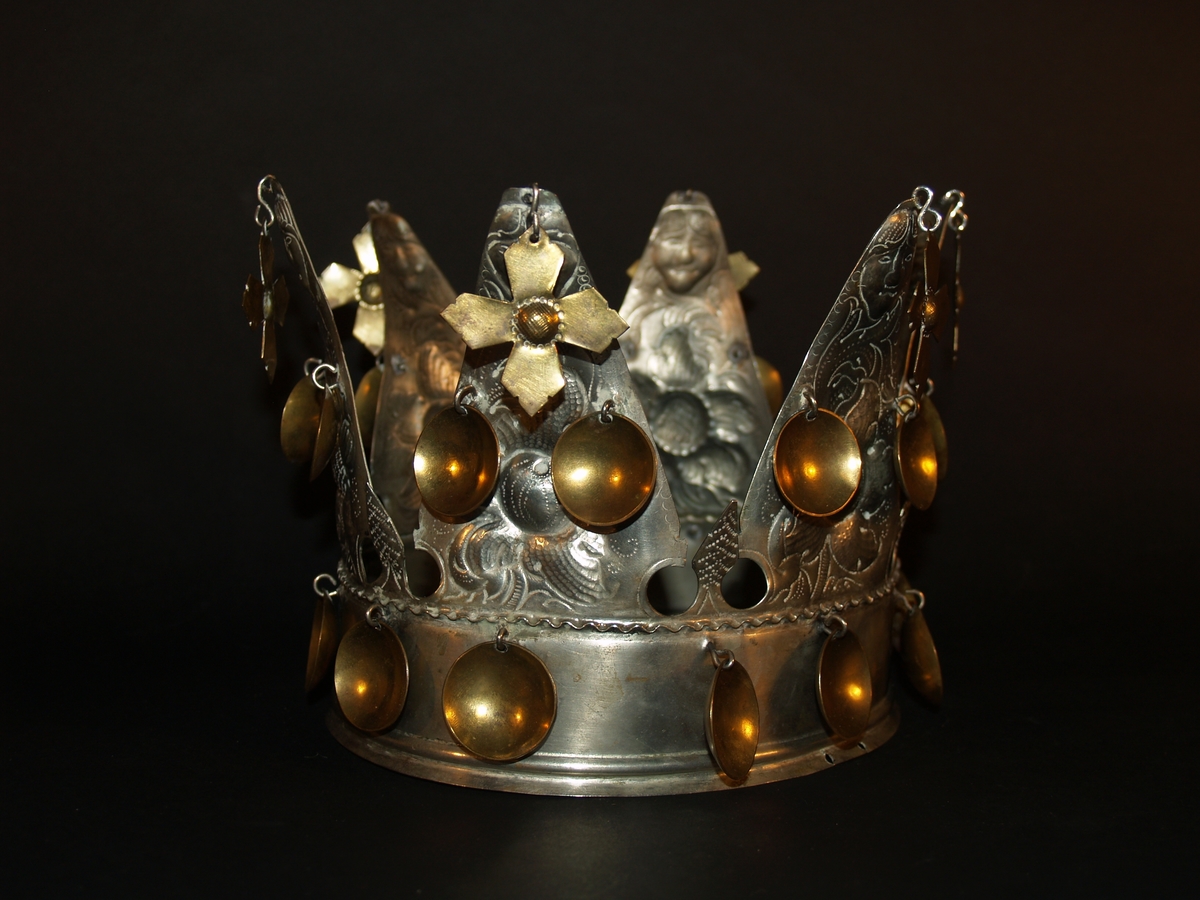Det er ei heilrend krone, det vil seie at den er klipt/sagd ut av ei metallplate og lodda saman. Den har seks taggar og er ei open krone. Kvar tagg er dekorerte med blomemønster og i toppen er det eit ansikt, som kan tolkast som annankvar mann og kvinne. I kvar tagg er det eit heng med eit kors i messing, det er også to blad i messing halvvegs opp på kvar tagg og 12 messingblad langs med ein bøljekant nede. Under blada er det ein glatt kant utan dekor, den glatte kanten avsluttast i to bølgjer. Denne glatte kanten er vanleg på kroner og her skal det vere eit band eller eit tøystykke. I ein avisartikkelen i avisa Samhold frå 1954 er krona vår avbilda med eit tøystykke rundt, og i tilvekstprotokollen er det ført inn at krona har eit raudt fløyelsband. Dette er seinare strøket over og tøystykket er dessverre borte.