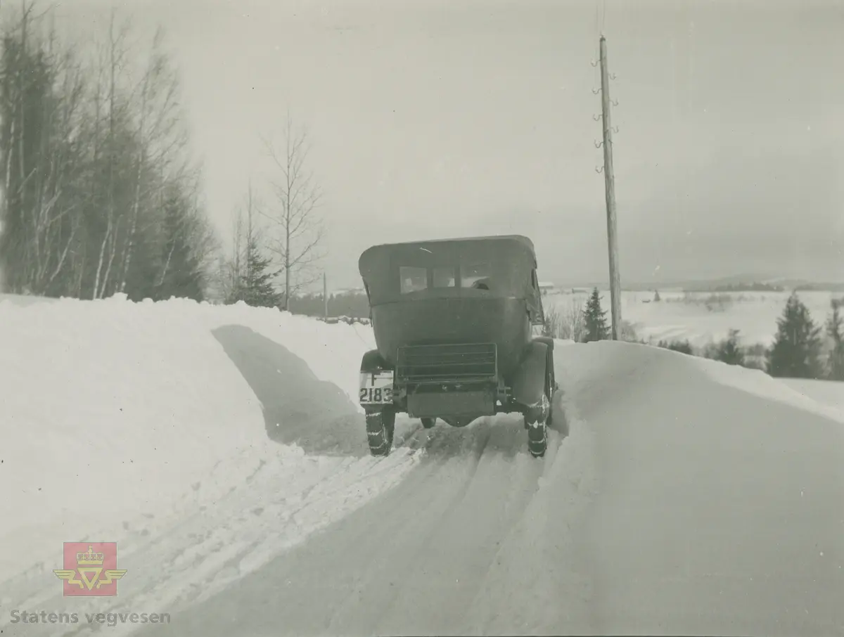 Album fra 1918-1934, "Snebrøyting." I følge merking: "Fra Lågendal 16.02.1926.  Veien brøytet med FWD og Akreplog."  Bilen er en Chandler 1923 eller 1924 modell med kjennemerke F-2183.  I 1925 var den eid av Chauffør Eskild Stordalen som også hadde den i 1928 og i 1930. Lågendalen er nedre del av dalføret som følger Numedalslågen i Vestfold og Buskerud.