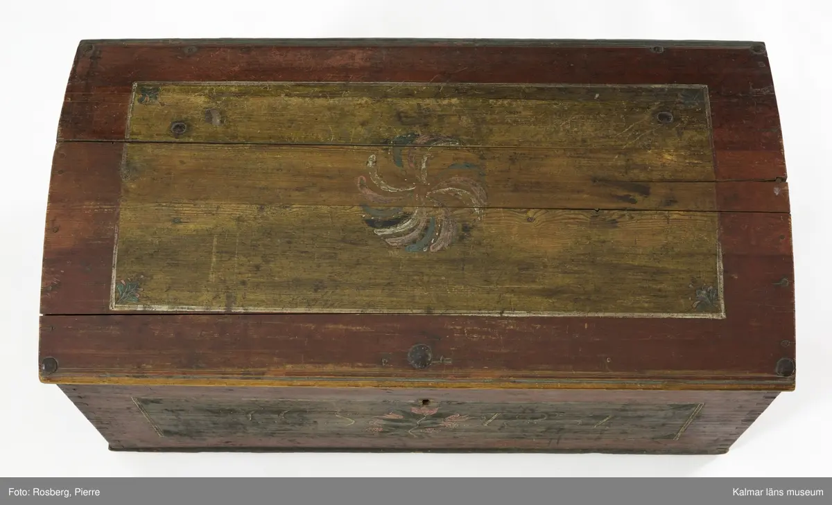 KLM 45384. Kista. Furu, järn. Kista med kupat lock och sinkade hörn. Bandgångjärn på insidan av locket och på baksidans utsida. På båda kortsidorna finns bärhandtag av smidesjärn. På fronten syns spår av en oval nyckelskylt, som nu ärborta. Lås saknas. Kistan står på fötter som är kraftigt nedslitna. Kistan är utvändigt bemålad med rödbrunt  ådringsmålat ramverk kring ekådrade fyllningar. Fronten är målad med initialerna J.G.S, årtalet 1831 i vitt, samt en blomsterslinga med sju blommor i rött. Baksidan är  enfärgad i rödbrunt. Inne i kistan finns på vänstra sidan en läddika med med ett lock målat i rödbrunt. I övrigt är kistan omålad invändigt.