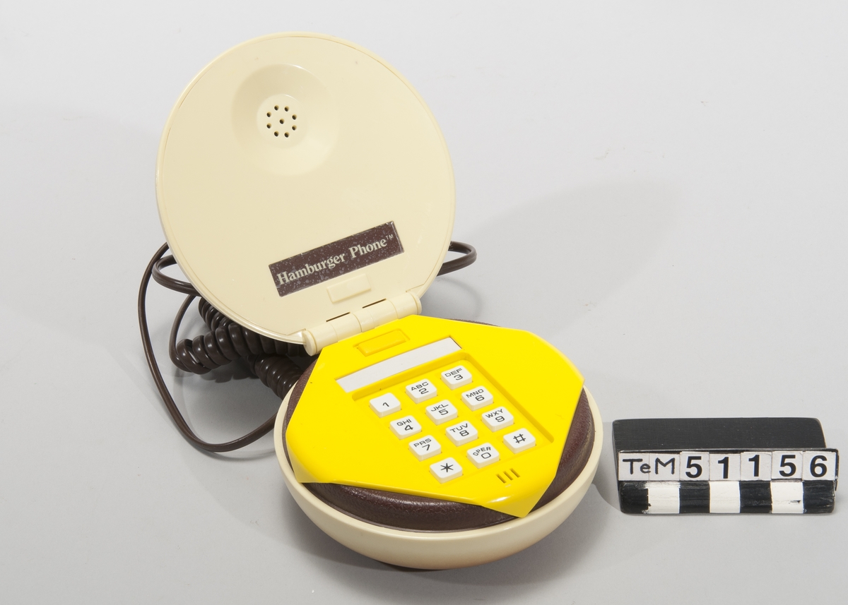Telefonapparat med pulsval, i originalkartong,i form av en hamburgare.