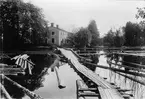 Sorteringsbrygga för timmer vid Forsbacka järnverk. I bakgrunden s.k. Klostret, bostad för brukstjänstemän.