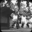 Skioptikonbild med motiv från Granada. Män sittande på café på torget plaza Rodriguez Bilobar.
Bilden har förvarats i kartong märkt: Höstresan 1910. Granada 9. N:7. Text på bild: 