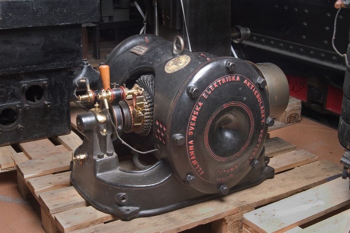 Skylt: "Motor No. 1720 Typ Mo Wenströms patent 110 volt 57 amp 6.9 hkr. 725 hv". Etikett i dekalkomani med bild av wenströms-dynamo. Solid järnmassa och inkapslad induktorlindning ger hög verkningsgrad.