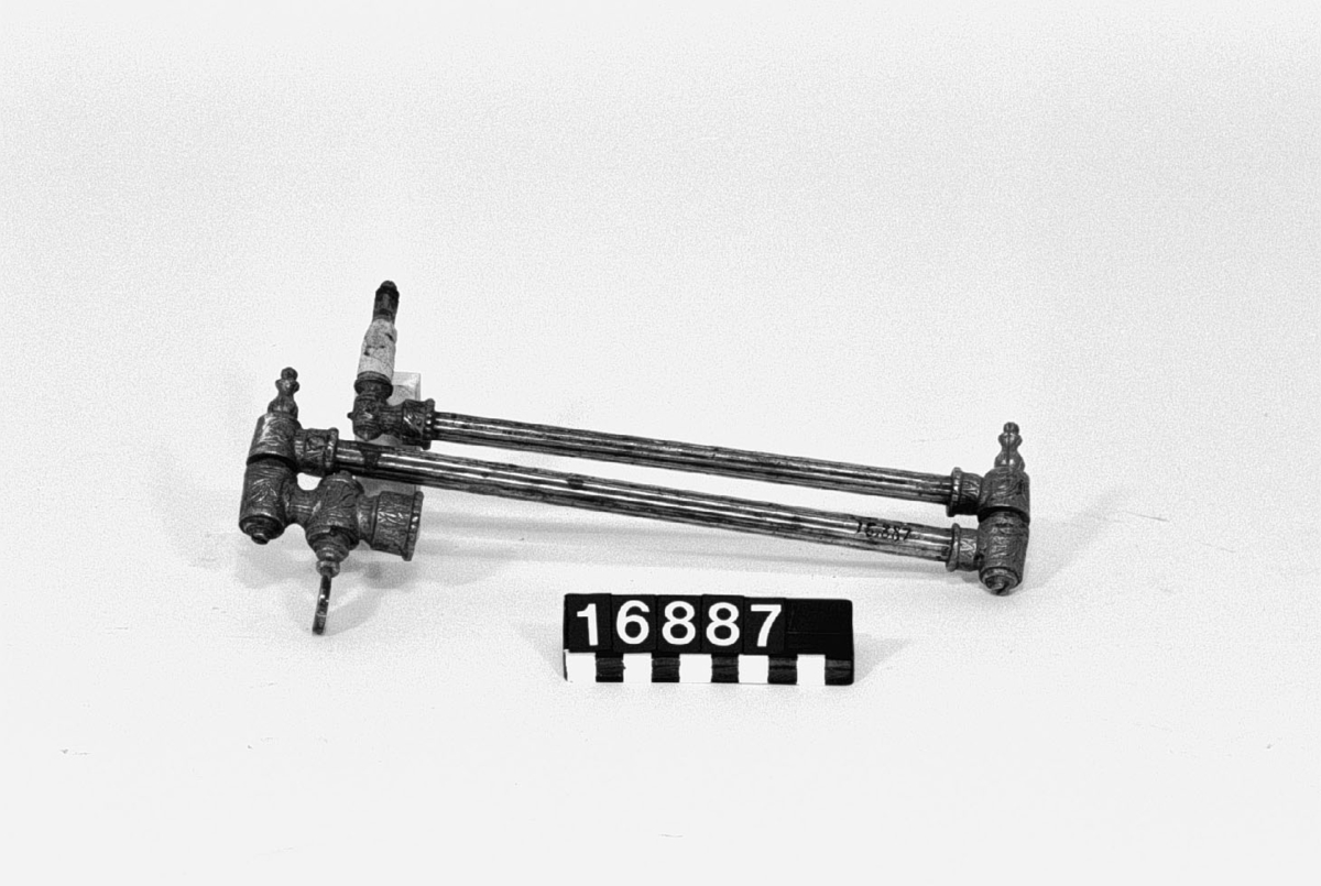 Gasarm av mässing, hopfällbar med två leder. Snittbrännare i ena änden.