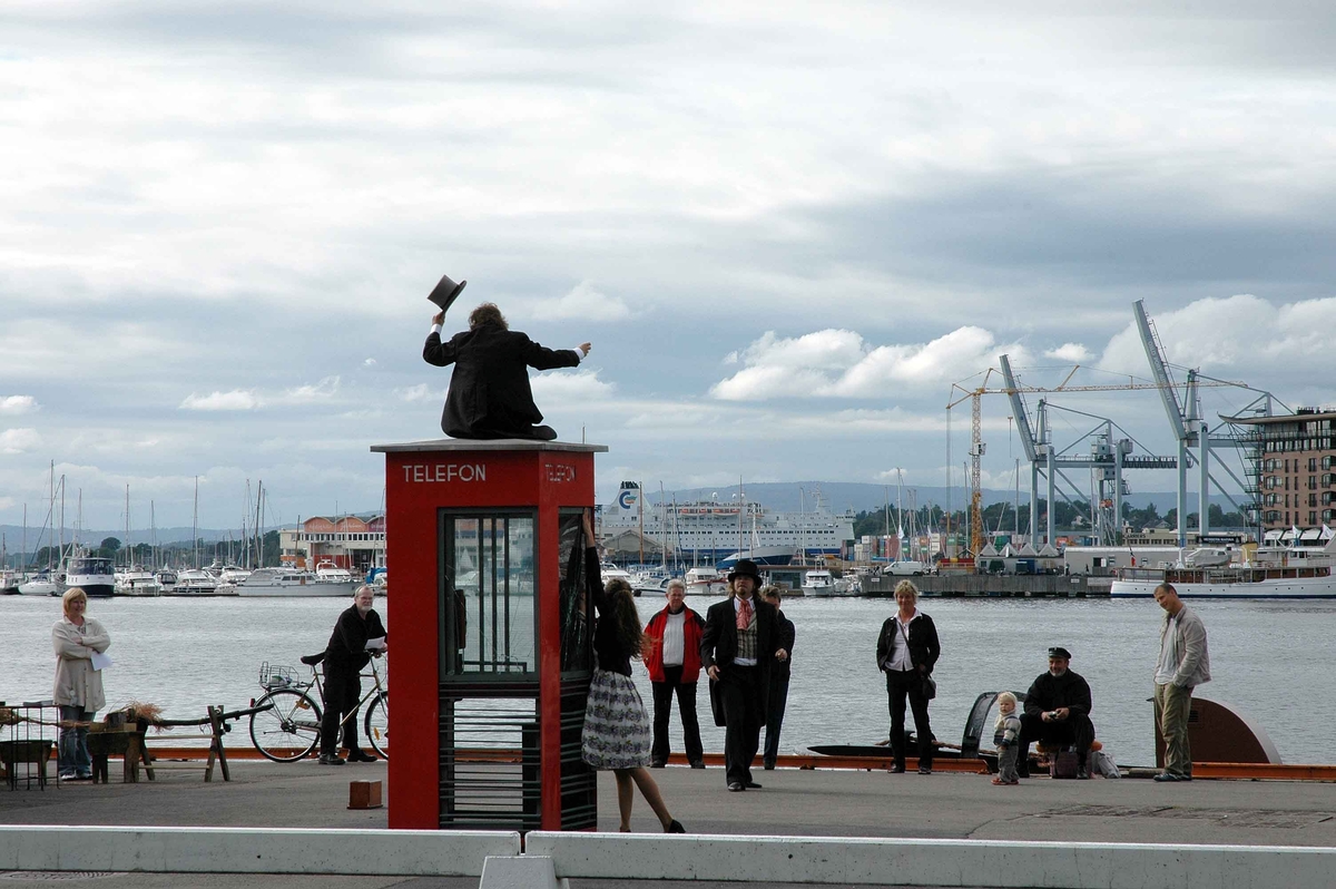This is the story of how Norway’s most important conversation-space was designed by a young, freshly graduated man from Bergen.

“Norwegian architects are hereby invited…”
In the autumn of 1932, Oslo Telefonanlegginitiated an architectural competition. Finally, Oslo would get its own telephone booth. The city had had so called “talking-stations” from 1885, which in turn were overtaken by automatic telephones 
 only available at selected Narvesen kiosks. The state 
was of the opinion that now was the time to offer the public a better service; public telephone booths open 24/7, like the ones they already had in Sweden and England. But what would they look like, these new telephone booths? What considerations would it
 be necessary to take when designing it? The telegraph board developed a detailed list of demands and restraints: “The booth is intended to be placed outside on the streets and squares and need to be designed so that snow and ice does not hinder the opening and closing of the doors,” they wrote. “To prevent vandalism, theft, uncleanliness etc. inside the booth, it needs to be designed so that from all angles one may see what is going on in there.” Additionally, it would need to withstand storms and bad weather, and “preferably also being whipped by rain mixed with seawater” 

This was not all: The appearance would have to be «pleasing». The booth also needed to be movable, so that it could be taken in to be serviced at Telegrafverket’s main workshops. The reqired material was iron, and the surface was to be spray painted  preferably using car-body paint. There was a requirement for “a writing shelf, a pack shelf, and a suitable place for the telephone catalogue.” Also, there would need to be an illuminated TELEFON  sign, easily visible from all four angles. The total cost for each booth should not exceed 1000 kroner. The first prize for coming up with such a product was 800 kroner.

“Norwegianarchitects are hereby invited to partake in a competition for the design of a telephone booth…”  

The man with the solution
«At some point in 1932, Georg Fredrik sat at a party in Bergen. Maybe he felt a bit lost and forgotten as he often had throughout his life. He retreated to a quiet corner, took out a pencil and strted doodling on a matchbox.  According to my mother, this was how the telephone booth came into being.” In the book “Norges lille røde  historien om telefonkiosken,” Lars Fasting describes his father, the man who is far less known than the iconic architctural structure he left behind. Georg Fredrik Fasting was from Bergen, born into a family of working people and smallholders. One unusual facet of Georg Fredrik was that he was born without ears. His mother made sure he learnt to speak, read and write, 
ut Lars Fasting indicates that his father would seek refuge in drawing when the social challenges became too much to bear. And in the end drawing became his profession. In 1924 he secured a guarantor for a student loan, and started studying to become an a
rchitect at the NTH. Throughout the 1930s he entered several architectural competitions, with drafts produced, according to his son, “after work and in the late hours of the night.”

His efforts were not wasted. Out of 93 entries, with names such as “Flirt”, “Brrr”, “Ring” and “Amor”, the jury selected Fasting’s submission, “RIKS” as the new telephone booth: “The draft shows a strikingly simple solution to the task, technically as well as aesthetically well worked out.”

Taut and provident
Simple and aesthetc are the keywords here. Fasting had designed a booth pointing towards the future, and to modernism. Just how modern it was can be seen by comparing RIKS to the British telephone booth, also designed in the interwar-era. While the British version with it classicistic style is looking back to the heyday of the empire, Fasting’s booth is progressive and functionalistic. Like most Norwegian architects, Fasting broke with the classicistic style of architecture after the Stockholm-exhibition in 1930. “After it, almost all buildings erected in Norway until the German invasion in 1940, were in the functionalistic architectural style,” writes senior curator of architecture at the Norwegian National Museum, Ulf Grønvold, in the book, “Den lille røde”.“TheNorwegian booth is a piece of functionalistic architecture, an asymmetric composition with its roof slab overhanging the word TELEFON, in bold sans seraph lettering,”concludes Ulf Grønvold.

Fashionably red
And it was red. Fasting chose a colour which was part of the modern palette. “A bright red colour, but not as shiny as a signal red, the character of the colour places it among the fashionable colours within functionalism,” states paintings conservator and researcher in NIKU (Norwegian Institute for Cultural Heitage Research), Jon Brænne. In his opinion, Fasting went for visibility without making the booth stand out too much from its surroundings. The original colour was in use up to around 1950, when it changed to signal red. Towards the end of the 1970s the clour was again adjusted towards today’s orangey red.

The design, however, has not changed. RIKS is eighty years and still looks remarkably good. That’s what makes Fasting’s telephone booth a classic  even before it was added to DOCOMOMO’s list over moden icons of design. For Telenor, the telephone booth has served as a pathway into the hearts of the public. For many, Telenor (Televerket) was synonymous with exactly this telephone booth, because this was where one would go to place a call. Having a home
phone was not common until the 1980s. As such the red box became part of the Norwegian everyday and consciousness. The symbol- and publicity value of this is hard to evaluate, but in 2007 it was time to give honour where honour was due, Telenor, in consul
tation with the Directorate for Cultural Heritage, decided to preserve 100 telephone booths for all eternity.

And what about Georg Fredrik Fasting? What happened to him? At the age of 56 an entry in his diary states: «I CAN HEAR». As the first person in th world he had undergone an operation where he had ear canals constructed and eardrums fitted. For the rest of his life, the man behind Norway’s own telephone booth could answer the telephone himself.

Source: Norges lille røde historien om telefonkiosken (2007), issued by The Norwegian Telecom Museum and Telenor Cultural Heritage.