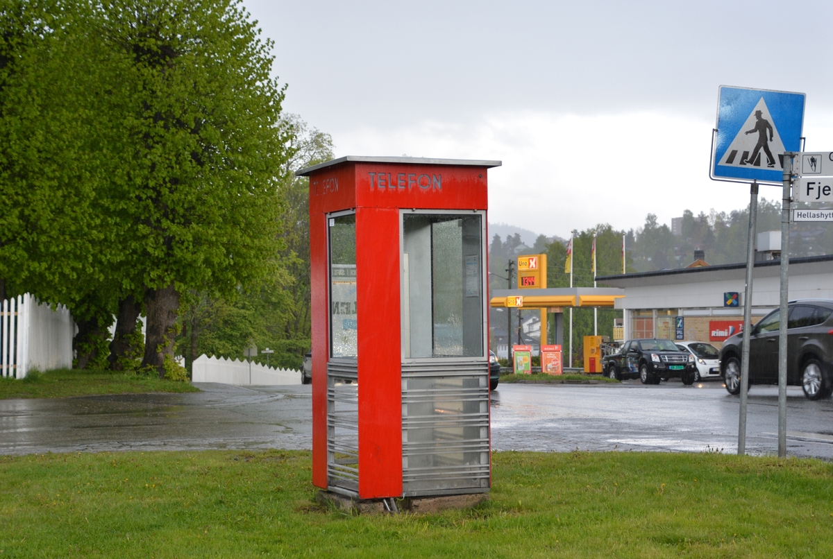 This is the story of how Norway’s most important conversation-space was designed by a young, freshly graduated man from Bergen.

“Norwegian architects are hereby invited…”
In the autumn of 1932, Oslo Telefonanlegginitiated an architectural competition. Finally, Oslo would get its own telephone booth. The city had had so called “talking-stations” from 1885, which in turn were overtaken by automatic telephones 
 only available at selected Narvesen kiosks. The state 
was of the opinion that now was the time to offer the public a better service; public telephone booths open 24/7, like the ones they already had in Sweden and England. But what would they look like, these new telephone booths? What considerations would it
 be necessary to take when designing it? The telegraph board developed a detailed list of demands and restraints: “The booth is intended to be placed outside on the streets and squares and need to be designed so that snow and ice does not hinder the opening and closing of the doors,” they wrote. “To prevent vandalism, theft, uncleanliness etc. inside the booth, it needs to be designed so that from all angles one may see what is going on in there.” Additionally, it would need to withstand storms and bad weather, and “preferably also being whipped by rain mixed with seawater” 

This was not all: The appearance would have to be «pleasing». The booth also needed to be movable, so that it could be taken in to be serviced at Telegrafverket’s main workshops. The reqired material was iron, and the surface was to be spray painted  preferably using car-body paint. There was a requirement for “a writing shelf, a pack shelf, and a suitable place for the telephone catalogue.” Also, there would need to be an illuminated TELEFON  sign, easily visible from all four angles. The total cost for each booth should not exceed 1000 kroner. The first prize for coming up with such a product was 800 kroner.

“Norwegianarchitects are hereby invited to partake in a competition for the design of a telephone booth…”  

The man with the solution
«At some point in 1932, Georg Fredrik sat at a party in Bergen. Maybe he felt a bit lost and forgotten as he often had throughout his life. He retreated to a quiet corner, took out a pencil and strted doodling on a matchbox.  According to my mother, this was how the telephone booth came into being.” In the book “Norges lille røde  historien om telefonkiosken,” Lars Fasting describes his father, the man who is far less known than the iconic architctural structure he left behind. Georg Fredrik Fasting was from Bergen, born into a family of working people and smallholders. One unusual facet of Georg Fredrik was that he was born without ears. His mother made sure he learnt to speak, read and write, 
ut Lars Fasting indicates that his father would seek refuge in drawing when the social challenges became too much to bear. And in the end drawing became his profession. In 1924 he secured a guarantor for a student loan, and started studying to become an a
rchitect at the NTH. Throughout the 1930s he entered several architectural competitions, with drafts produced, according to his son, “after work and in the late hours of the night.”

His efforts were not wasted. Out of 93 entries, with names such as “Flirt”, “Brrr”, “Ring” and “Amor”, the jury selected Fasting’s submission, “RIKS” as the new telephone booth: “The draft shows a strikingly simple solution to the task, technically as well as aesthetically well worked out.”

Taut and provident
Simple and aesthetc are the keywords here. Fasting had designed a booth pointing towards the future, and to modernism. Just how modern it was can be seen by comparing RIKS to the British telephone booth, also designed in the interwar-era. While the British version with it classicistic style is looking back to the heyday of the empire, Fasting’s booth is progressive and functionalistic. Like most Norwegian architects, Fasting broke with the classicistic style of architecture after the Stockholm-exhibition in 1930. “After it, almost all buildings erected in Norway until the German invasion in 1940, were in the functionalistic architectural style,” writes senior curator of architecture at the Norwegian National Museum, Ulf Grønvold, in the book, “Den lille røde”.“TheNorwegian booth is a piece of functionalistic architecture, an asymmetric composition with its roof slab overhanging the word TELEFON, in bold sans seraph lettering,”concludes Ulf Grønvold.

Fashionably red
And it was red. Fasting chose a colour which was part of the modern palette. “A bright red colour, but not as shiny as a signal red, the character of the colour places it among the fashionable colours within functionalism,” states paintings conservator and researcher in NIKU (Norwegian Institute for Cultural Heitage Research), Jon Brænne. In his opinion, Fasting went for visibility without making the booth stand out too much from its surroundings. The original colour was in use up to around 1950, when it changed to signal red. Towards the end of the 1970s the clour was again adjusted towards today’s orangey red.

The design, however, has not changed. RIKS is eighty years and still looks remarkably good. That’s what makes Fasting’s telephone booth a classic  even before it was added to DOCOMOMO’s list over moden icons of design. For Telenor, the telephone booth has served as a pathway into the hearts of the public. For many, Telenor (Televerket) was synonymous with exactly this telephone booth, because this was where one would go to place a call. Having a home
phone was not common until the 1980s. As such the red box became part of the Norwegian everyday and consciousness. The symbol- and publicity value of this is hard to evaluate, but in 2007 it was time to give honour where honour was due, Telenor, in consul
tation with the Directorate for Cultural Heritage, decided to preserve 100 telephone booths for all eternity.

And what about Georg Fredrik Fasting? What happened to him? At the age of 56 an entry in his diary states: «I CAN HEAR». As the first person in th world he had undergone an operation where he had ear canals constructed and eardrums fitted. For the rest of his life, the man behind Norway’s own telephone booth could answer the telephone himself.

Source: Norges lille røde historien om telefonkiosken (2007), issued by The Norwegian Telecom Museum and Telenor Cultural Heritage.