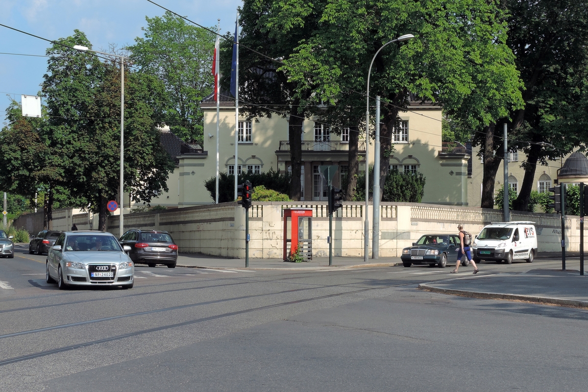 This is the story of how Norway’s most important conversation-space was designed by a young, freshly graduated man from Bergen.

“Norwegian architects are hereby invited…”
In the autumn of 1932, Oslo Telefonanlegginitiated an architectural competition. Finally, Oslo would get its own telephone booth. The city had had so called “talking-stations” from 1885, which in turn were overtaken by automatic telephones 
 only available at selected Narvesen kiosks. The state 
was of the opinion that now was the time to offer the public a better service; public telephone booths open 24/7, like the ones they already had in Sweden and England. But what would they look like, these new telephone booths? What considerations would it
 be necessary to take when designing it? The telegraph board developed a detailed list of demands and restraints: “The booth is intended to be placed outside on the streets and squares and need to be designed so that snow and ice does not hinder the opening and closing of the doors,” they wrote. “To prevent vandalism, theft, uncleanliness etc. inside the booth, it needs to be designed so that from all angles one may see what is going on in there.” Additionally, it would need to withstand storms and bad weather, and “preferably also being whipped by rain mixed with seawater” 

This was not all: The appearance would have to be «pleasing». The booth also needed to be movable, so that it could be taken in to be serviced at Telegrafverket’s main workshops. The reqired material was iron, and the surface was to be spray painted  preferably using car-body paint. There was a requirement for “a writing shelf, a pack shelf, and a suitable place for the telephone catalogue.” Also, there would need to be an illuminated TELEFON  sign, easily visible from all four angles. The total cost for each booth should not exceed 1000 kroner. The first prize for coming up with such a product was 800 kroner.

“Norwegianarchitects are hereby invited to partake in a competition for the design of a telephone booth…”  

The man with the solution
«At some point in 1932, Georg Fredrik sat at a party in Bergen. Maybe he felt a bit lost and forgotten as he often had throughout his life. He retreated to a quiet corner, took out a pencil and strted doodling on a matchbox.  According to my mother, this was how the telephone booth came into being.” In the book “Norges lille røde  historien om telefonkiosken,” Lars Fasting describes his father, the man who is far less known than the iconic architctural structure he left behind. Georg Fredrik Fasting was from Bergen, born into a family of working people and smallholders. One unusual facet of Georg Fredrik was that he was born without ears. His mother made sure he learnt to speak, read and write, 
ut Lars Fasting indicates that his father would seek refuge in drawing when the social challenges became too much to bear. And in the end drawing became his profession. In 1924 he secured a guarantor for a student loan, and started studying to become an a
rchitect at the NTH. Throughout the 1930s he entered several architectural competitions, with drafts produced, according to his son, “after work and in the late hours of the night.”

His efforts were not wasted. Out of 93 entries, with names such as “Flirt”, “Brrr”, “Ring” and “Amor”, the jury selected Fasting’s submission, “RIKS” as the new telephone booth: “The draft shows a strikingly simple solution to the task, technically as well as aesthetically well worked out.”

Taut and provident
Simple and aesthetc are the keywords here. Fasting had designed a booth pointing towards the future, and to modernism. Just how modern it was can be seen by comparing RIKS to the British telephone booth, also designed in the interwar-era. While the British version with it classicistic style is looking back to the heyday of the empire, Fasting’s booth is progressive and functionalistic. Like most Norwegian architects, Fasting broke with the classicistic style of architecture after the Stockholm-exhibition in 1930. “After it, almost all buildings erected in Norway until the German invasion in 1940, were in the functionalistic architectural style,” writes senior curator of architecture at the Norwegian National Museum, Ulf Grønvold, in the book, “Den lille røde”.“TheNorwegian booth is a piece of functionalistic architecture, an asymmetric composition with its roof slab overhanging the word TELEFON, in bold sans seraph lettering,”concludes Ulf Grønvold.

Fashionably red
And it was red. Fasting chose a colour which was part of the modern palette. “A bright red colour, but not as shiny as a signal red, the character of the colour places it among the fashionable colours within functionalism,” states paintings conservator and researcher in NIKU (Norwegian Institute for Cultural Heitage Research), Jon Brænne. In his opinion, Fasting went for visibility without making the booth stand out too much from its surroundings. The original colour was in use up to around 1950, when it changed to signal red. Towards the end of the 1970s the clour was again adjusted towards today’s orangey red.

The design, however, has not changed. RIKS is eighty years and still looks remarkably good. That’s what makes Fasting’s telephone booth a classic  even before it was added to DOCOMOMO’s list over moden icons of design. For Telenor, the telephone booth has served as a pathway into the hearts of the public. For many, Telenor (Televerket) was synonymous with exactly this telephone booth, because this was where one would go to place a call. Having a home
phone was not common until the 1980s. As such the red box became part of the Norwegian everyday and consciousness. The symbol- and publicity value of this is hard to evaluate, but in 2007 it was time to give honour where honour was due, Telenor, in consul
tation with the Directorate for Cultural Heritage, decided to preserve 100 telephone booths for all eternity.

And what about Georg Fredrik Fasting? What happened to him? At the age of 56 an entry in his diary states: «I CAN HEAR». As the first person in th world he had undergone an operation where he had ear canals constructed and eardrums fitted. For the rest of his life, the man behind Norway’s own telephone booth could answer the telephone himself.

Source: Norges lille røde historien om telefonkiosken (2007), issued by The Norwegian Telecom Museum and Telenor Cultural Heritage.