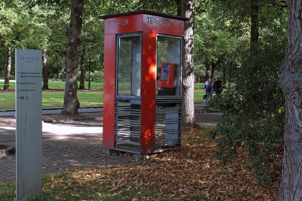 This is the story of how Norway’s most important conversation-space was designed by a young, freshly graduated man from Bergen.

“Norwegian architects are hereby invited…”
In the autumn of 1932, Oslo Telefonanlegginitiated an architectural competition. Finally, Oslo would get its own telephone booth. The city had had so called “talking-stations” from 1885, which in turn were overtaken by automatic telephones 
 only available at selected Narvesen kiosks. The state 
was of the opinion that now was the time to offer the public a better service; public telephone booths open 24/7, like the ones they already had in Sweden and England. But what would they look like, these new telephone booths? What considerations would it
 be necessary to take when designing it? The telegraph board developed a detailed list of demands and restraints: “The booth is intended to be placed outside on the streets and squares and need to be designed so that snow and ice does not hinder the opening and closing of the doors,” they wrote. “To prevent vandalism, theft, uncleanliness etc. inside the booth, it needs to be designed so that from all angles one may see what is going on in there.” Additionally, it would need to withstand storms and bad weather, and “preferably also being whipped by rain mixed with seawater” 

This was not all: The appearance would have to be «pleasing». The booth also needed to be movable, so that it could be taken in to be serviced at Telegrafverket’s main workshops. The reqired material was iron, and the surface was to be spray painted  preferably using car-body paint. There was a requirement for “a writing shelf, a pack shelf, and a suitable place for the telephone catalogue.” Also, there would need to be an illuminated TELEFON  sign, easily visible from all four angles. The total cost for each booth should not exceed 1000 kroner. The first prize for coming up with such a product was 800 kroner.

“Norwegianarchitects are hereby invited to partake in a competition for the design of a telephone booth…”  

The man with the solution
«At some point in 1932, Georg Fredrik sat at a party in Bergen. Maybe he felt a bit lost and forgotten as he often had throughout his life. He retreated to a quiet corner, took out a pencil and strted doodling on a matchbox.  According to my mother, this was how the telephone booth came into being.” In the book “Norges lille røde  historien om telefonkiosken,” Lars Fasting describes his father, the man who is far less known than the iconic architctural structure he left behind. Georg Fredrik Fasting was from Bergen, born into a family of working people and smallholders. One unusual facet of Georg Fredrik was that he was born without ears. His mother made sure he learnt to speak, read and write, 
ut Lars Fasting indicates that his father would seek refuge in drawing when the social challenges became too much to bear. And in the end drawing became his profession. In 1924 he secured a guarantor for a student loan, and started studying to become an a
rchitect at the NTH. Throughout the 1930s he entered several architectural competitions, with drafts produced, according to his son, “after work and in the late hours of the night.”

His efforts were not wasted. Out of 93 entries, with names such as “Flirt”, “Brrr”, “Ring” and “Amor”, the jury selected Fasting’s submission, “RIKS” as the new telephone booth: “The draft shows a strikingly simple solution to the task, technically as well as aesthetically well worked out.”

Taut and provident
Simple and aesthetc are the keywords here. Fasting had designed a booth pointing towards the future, and to modernism. Just how modern it was can be seen by comparing RIKS to the British telephone booth, also designed in the interwar-era. While the British version with it classicistic style is looking back to the heyday of the empire, Fasting’s booth is progressive and functionalistic. Like most Norwegian architects, Fasting broke with the classicistic style of architecture after the Stockholm-exhibition in 1930. “After it, almost all buildings erected in Norway until the German invasion in 1940, were in the functionalistic architectural style,” writes senior curator of architecture at the Norwegian National Museum, Ulf Grønvold, in the book, “Den lille røde”.“TheNorwegian booth is a piece of functionalistic architecture, an asymmetric composition with its roof slab overhanging the word TELEFON, in bold sans seraph lettering,”concludes Ulf Grønvold.

Fashionably red
And it was red. Fasting chose a colour which was part of the modern palette. “A bright red colour, but not as shiny as a signal red, the character of the colour places it among the fashionable colours within functionalism,” states paintings conservator and researcher in NIKU (Norwegian Institute for Cultural Heitage Research), Jon Brænne. In his opinion, Fasting went for visibility without making the booth stand out too much from its surroundings. The original colour was in use up to around 1950, when it changed to signal red. Towards the end of the 1970s the clour was again adjusted towards today’s orangey red.

The design, however, has not changed. RIKS is eighty years and still looks remarkably good. That’s what makes Fasting’s telephone booth a classic  even before it was added to DOCOMOMO’s list over moden icons of design. For Telenor, the telephone booth has served as a pathway into the hearts of the public. For many, Telenor (Televerket) was synonymous with exactly this telephone booth, because this was where one would go to place a call. Having a home
phone was not common until the 1980s. As such the red box became part of the Norwegian everyday and consciousness. The symbol- and publicity value of this is hard to evaluate, but in 2007 it was time to give honour where honour was due, Telenor, in consul
tation with the Directorate for Cultural Heritage, decided to preserve 100 telephone booths for all eternity.

And what about Georg Fredrik Fasting? What happened to him? At the age of 56 an entry in his diary states: «I CAN HEAR». As the first person in th world he had undergone an operation where he had ear canals constructed and eardrums fitted. For the rest of his life, the man behind Norway’s own telephone booth could answer the telephone himself.

Source: Norges lille røde historien om telefonkiosken (2007), issued by The Norwegian Telecom Museum and Telenor Cultural Heritage.