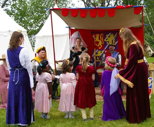 Little princesses in pretty dresses meeting the king and queen