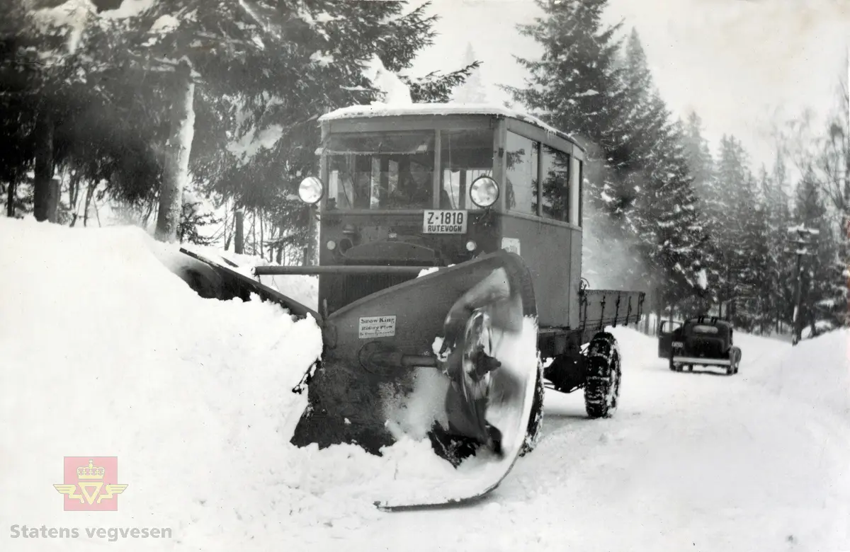 Snow King roterende snøplog, montert på en FWD 1918 modell fra første verdenskrig, i følge merking i album. Kjennetegn Z-1810 Rutevogn. Bildet kan være fra Kristiansand. I 1936-1937 kom det svært store snømengder på Sørlandet.  I bakgrunnen står Direktør Johnny Colbjørnsens 1937 modell Studebaker Dictator. 6 cyl som har kjennetegn A-3473. Bildet er fra et album av Colbjørnsen & Co A/S i perioden fra 1936-1950-tallet. 

01.06.2016: " FWD 1918 modell med kjennetegn Z-1810 var registrert på NSB-selskapet Lågendalsruten, Larvik."