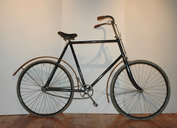 Cykel av stålrör. Diamond-ram. Lädersadel på metall-stomme och stavfjädrar, nedsvängt styre med skinnhandtag. Hjul av stålfälgar på suspensionsekrar. Luftfyllda gummidäck. Bakaxeln på vänster sida förlängd till fotsteg. Kedja av 2,3 cm långa länksidor förenade medelst massiva mellanstycken. Svart, styre och framgaffelkrona förkromade. På styrrörets framsida korsformig kartusch i metall mellan två, mot varandra vända nymånar. Text: "CRESCENT".