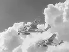 Fotomontage. Två flygplan B 18 i luften vid moln.