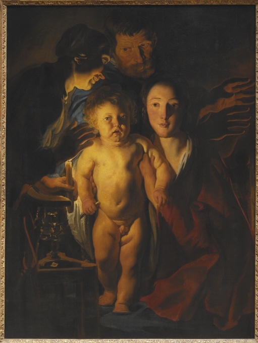 Jordaens vardagliga gestaltning av den Heliga familjen avspeglar caravaggismens mest intima karaktär. Den genreartade scenen utspelar sig på vintern, tiden för Jesu födelse. Det tända vaxljuset i tjänstekvinnans hand kompletteras av en eldstad utanför bildrummet vid vilken Josef värmer sina frusna händer. Det realistiskt skildrade Jesusbarnet står i Jungfru Marias knä. Genom blicken söker han kontakt med betraktaren, som för att bjuda oss att komma närmare och ansluta i tillbedjan. Med moderlig stolthet visar Maria upp Jesusbarnet. Kniven i Jesusbarnets hand hänsyftar till omskärelsen, det första tillfället då Frälsaren utgjuter sitt blod för våra synder, och uppmanar därmed till begrundan av Kristi passion. Målningens ikonografi härrör delvis från den heliga Birgittas uppenbarelser. Hon beskrev det nyfödda Jesusbarnet – ”världens ljus” – som källan till ett starkt övernaturligt ljus. Jordaens konkretiserar här den gudomliga strålglansen i form av det intensiva reflekterade skenet från vaxljusets låga.